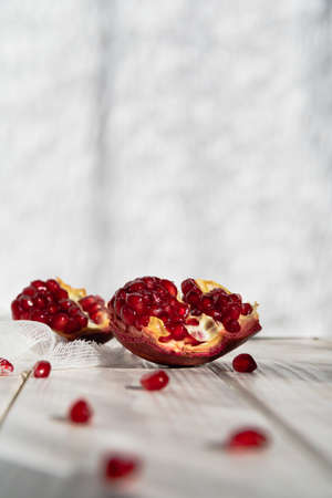 Pomegranate slice and seeds close-up. Selective focus. Space for text, copy space. Card.の写真素材
