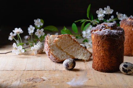 Still life of an Easter cake and a blossoming spring branch and quail eggs. Taste festive pastries in a rustic kitchen.の写真素材