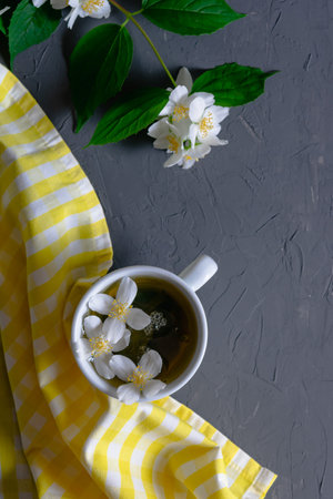 Top view cup of green tea with jasmine on a dark gray background. Cozy tea party. Fragrant healthy drink.の写真素材