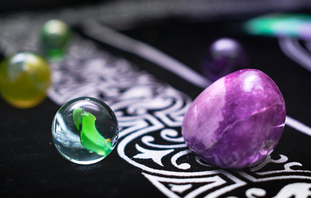 Macro still life with crystals and marbles on dark fabric. Great for abstract or spiritual designs.の写真素材