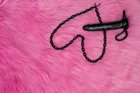 dark vibrator sex toy next to heart. Love composition means i love you on the pink fur background, declaration of love.の写真素材