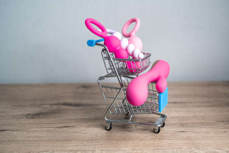 supermarket trolley filled with sex toys vibrator and anal butt plugs. Concept of buying adult toys, e shoppingの写真素材
