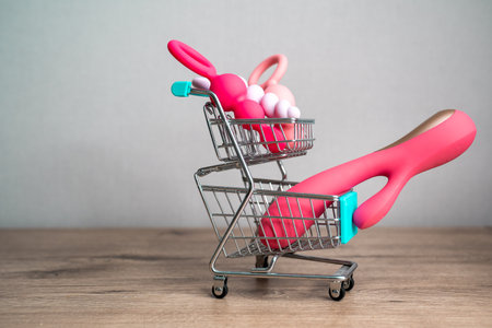 supermarket trolley filled with sex toys vibrator and anal butt plugs. Concept of buying adult toys, e shoppingの写真素材