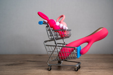 supermarket trolley filled with sex toys vibrator and anal butt plugs. Concept of buying adult toys, e shoppingの写真素材