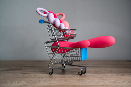 supermarket trolley filled with sex toys vibrator and anal butt plugs. Concept of buying adult toys, e shoppingの写真素材