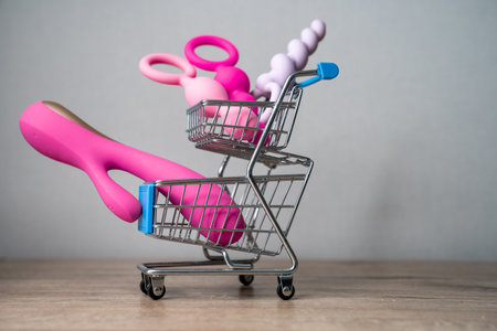 supermarket trolley filled with sex toys vibrator and anal butt plugs. Concept of buying adult toys, e shoppingの写真素材