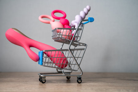 supermarket trolley filled with sex toys vibrator and anal butt plugs. Concept of buying adult toys, e shoppingの写真素材