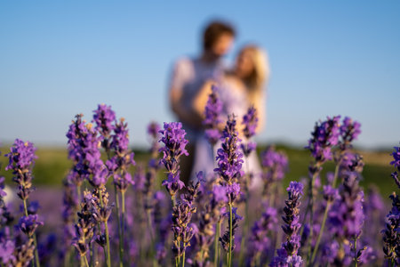 couple in purple lilac matching outfit hugging in lavender field, romantic photo sessionの写真素材