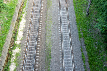 railway tracks on the road, view from above on the railway road, travelling, direction of wayの写真素材