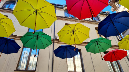 multi color umbrellas as street outdoor decoration, bright blue sky backgroundの写真素材