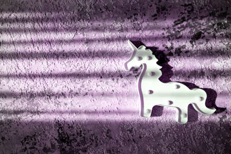 creative light effect, sunbeam stripes on purple violet background, white unicorn toy lamp, children toysの写真素材