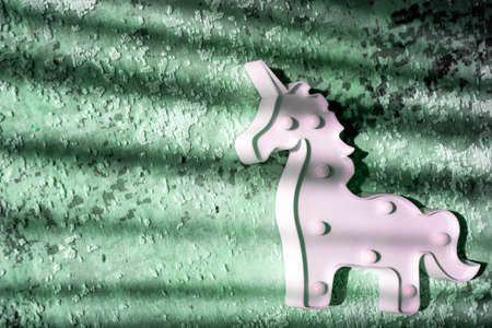 creative light effect, sunbeam stripes on green background, white unicorn toy  lampの写真素材