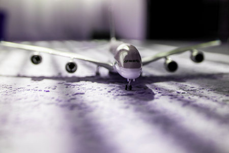 creative effect with sun light beam, airplane aircraft toy on purple violet background with lines, travelling conceptの写真素材
