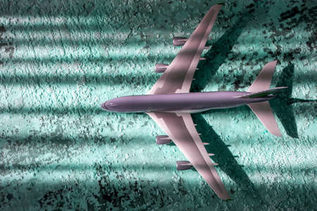 avia creative effect with sun light beam, airplane aircraft toy on green blue background with lines, travelling conceptの写真素材