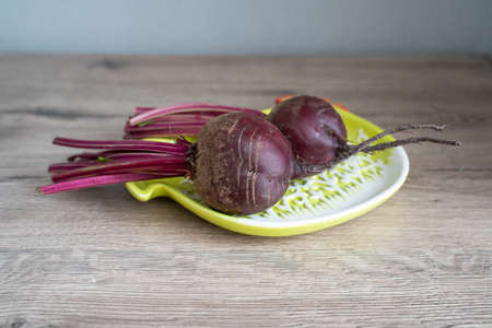 young beetroot on the chicken shaped plate, borsch main ingredient in the kitchen, root vegetable,  source of fiber, folate, b9, lower blood pressureの写真素材