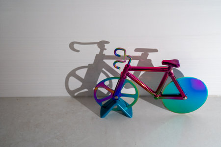 colorful bicycle and visible shadow, creative effect of sunlight, reflection on the wall, mirroring volume, healthy lifestyle, cardio exercise, fitness, children toy, sportの写真素材