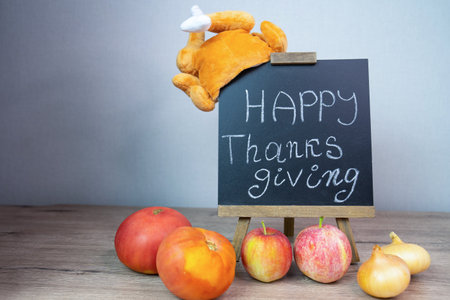 happy thanksgiving day, autumn background with text and inscription, plush turkey imitation and vegetables harvestの写真素材