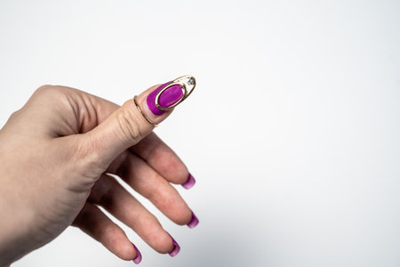 beautiful female hand with manicure on white background, nail decor jewelry, art design, creative accessoriesの写真素材