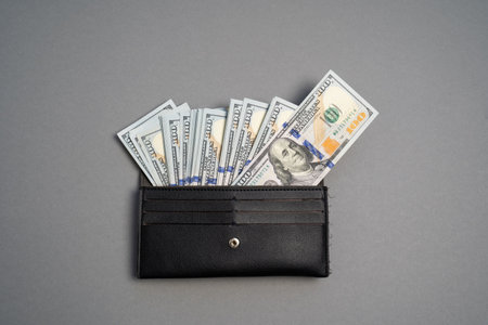 American dollar banknotes stack, pack of money in black wallet, rich, luxury, currency, spending money in crisis, benchmark currency, most used in transactions across the worldの写真素材