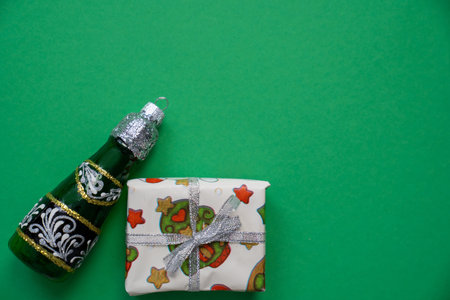 champagne bottle christmas decoration toy with wrapped gift box, happy holidays, merry christmas and festive new year, copy space for textの写真素材