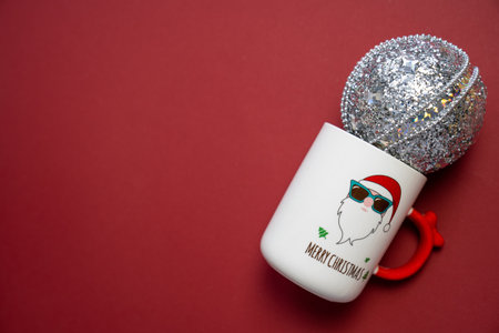 merry Christmas and happy new year, festive white cup with santa claus print, mug silver sparkly bauble, copy space, holiday celebrationの写真素材