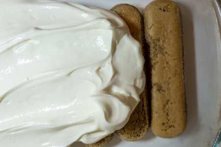tiramisu popular Italian dessert ingredients: mascarpone soft cream cheese and savoiardi biscuits, cooking processの写真素材