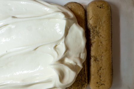 tiramisu popular Italian dessert ingredients: mascarpone soft cream cheese and savoiardi biscuits, cooking processの写真素材