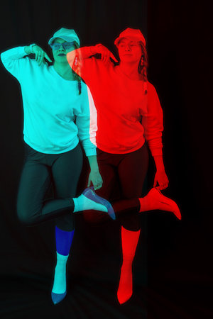 Stylish woman model posing on black background, rgb color split, abstract futuristic creative styleの写真素材