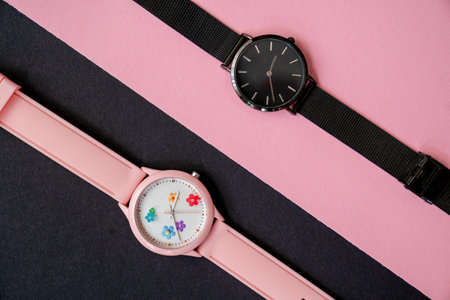 modern hand watches on black pink background, top view, flat lay of product, creative time expressionの写真素材