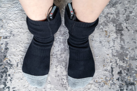 woman wears battery powered heated socks for cold winterの写真素材