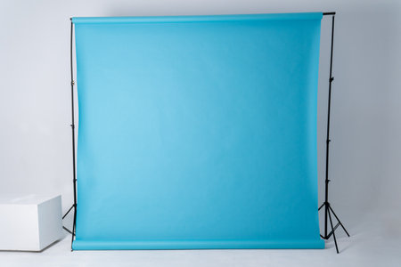 blue background on support system, support stands in photo studio. Photography equipment. Indoor or...