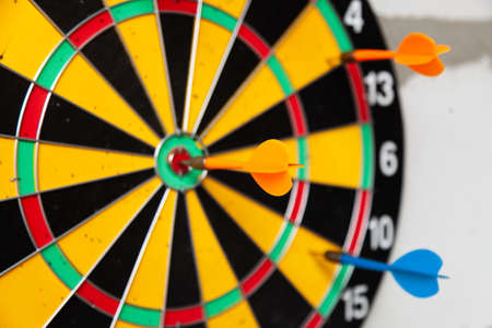Dartboard with colorful darts on it. Leisure activitiesの写真素材