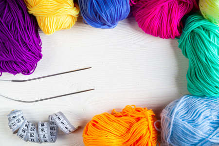 Balls of colored yarn on a white wooden background. Knitting. Top view.の写真素材