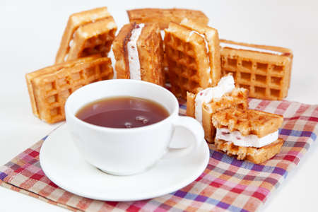 Belgian waffles and tea in a mug on the table. Tasty.の写真素材