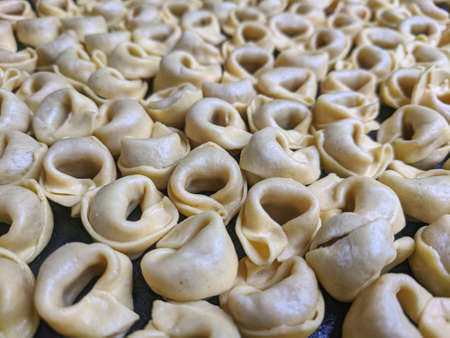 A close up top view shot of raw Tortellini with white mushrooms Texture Food photography backgroundの写真素材