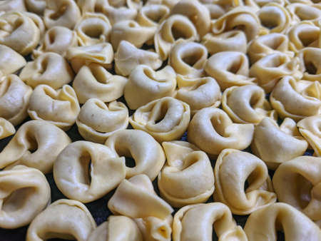 A close up top view shot of raw Tortellini with white mushrooms Texture Food photography backgroundの写真素材