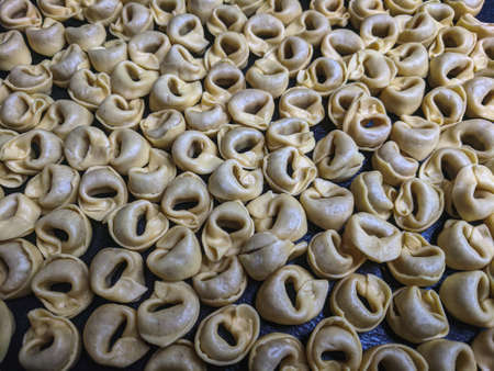 A close up top view shot of raw Tortellini with white mushrooms Texture Food photography backgroundの写真素材