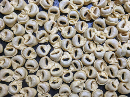A close up top view shot of raw Tortellini with white mushrooms Texture Food photography backgroundの写真素材