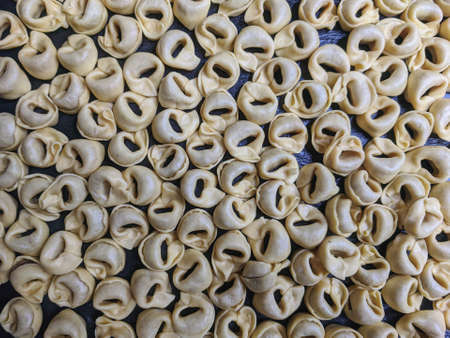 A close up top view shot of raw Tortellini with white mushrooms Texture Food photography backgroundの写真素材