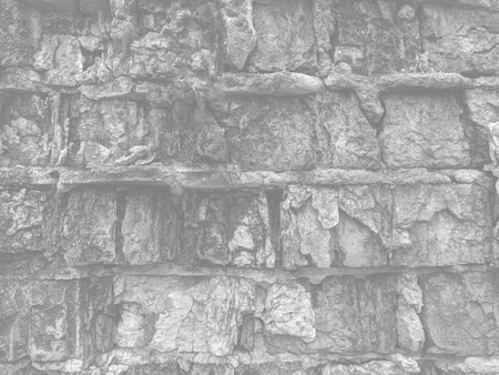 Background of stone wall texture close up. Monochrome photo.