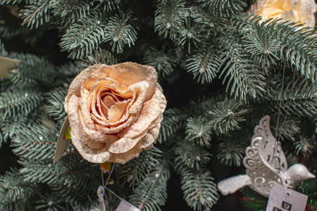 Christmas tree decoration with artificial rose flower and silver christmas ball.の写真素材