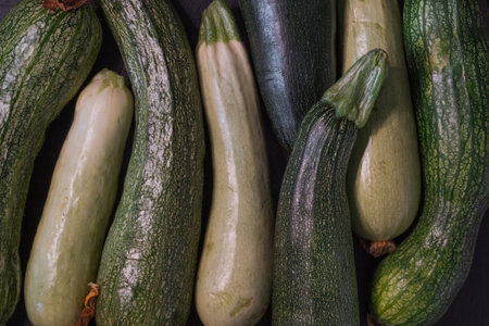 Fresh zucchini on a black background. Zucchini backgroundの写真素材