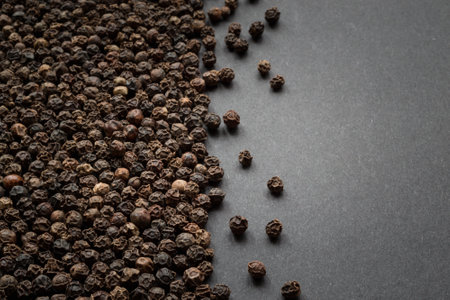 Black pepper on black background. Top view. Copy space for text.の写真素材