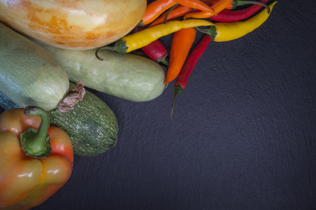 Various fresh vegetables on black slate background. Top view with copy spaceの写真素材