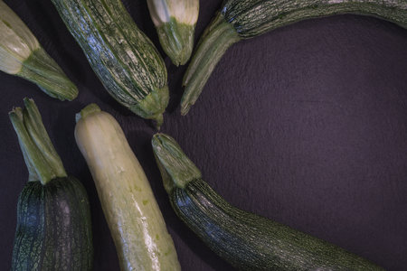 Fresh zucchini on black background. Top view with copy spaceの写真素材