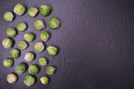 Fresh brussels sprouts on black slate background. Top viewの写真素材