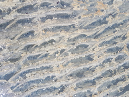 closeup of sand pattern on a beach in the south of italy