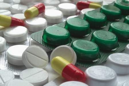 Pills and Capsules on White Tablets Background, Medical Concept