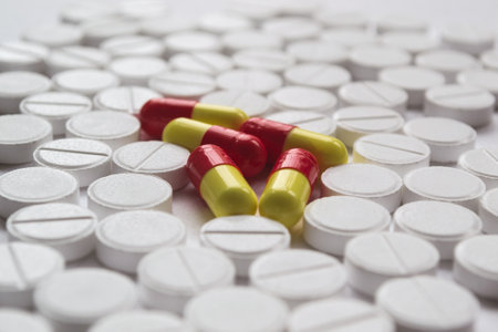 Colorful pills and capsules on white background. Focus on foreground, soft bokeh.の写真素材