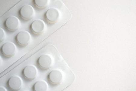 Close up of white pills in blister pack on white background with copy spaceの写真素材
